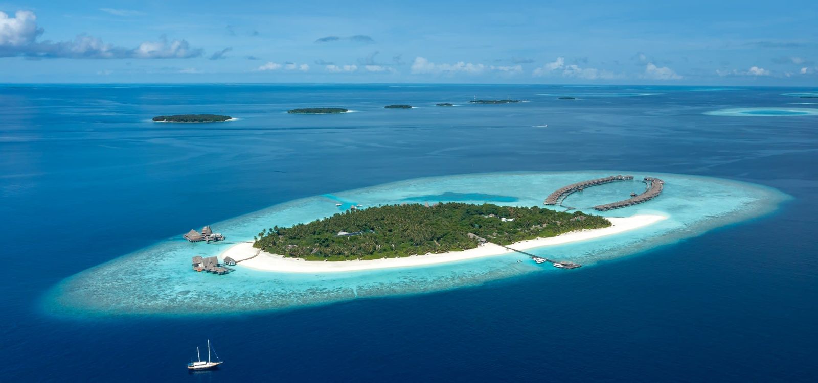 Aerial view of Anantara Kihavah island and its overwater villas