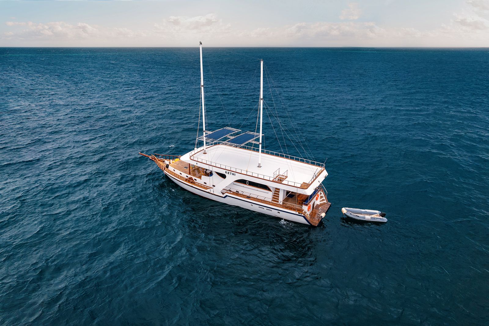 Aerial view of Kethi at sea with its dinghy