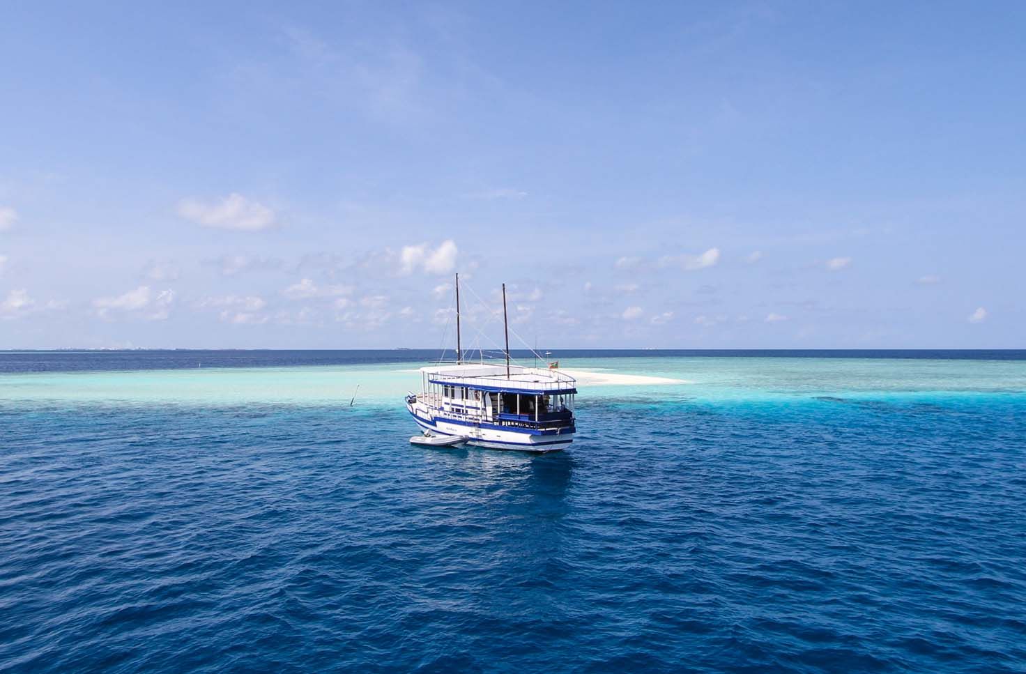 Koimala at anchor beside a sandbank